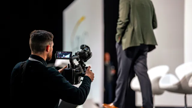 A camera operator filming the main stage